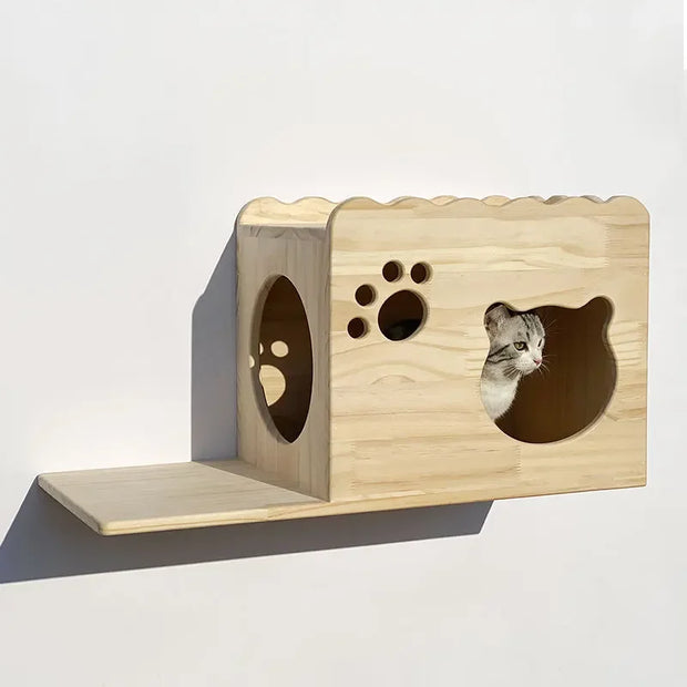 Wooden cat climbing frame with luxury wall-mounted cat house and shelf. Features a cozy enclosed space with cat-shaped and paw print cutouts.